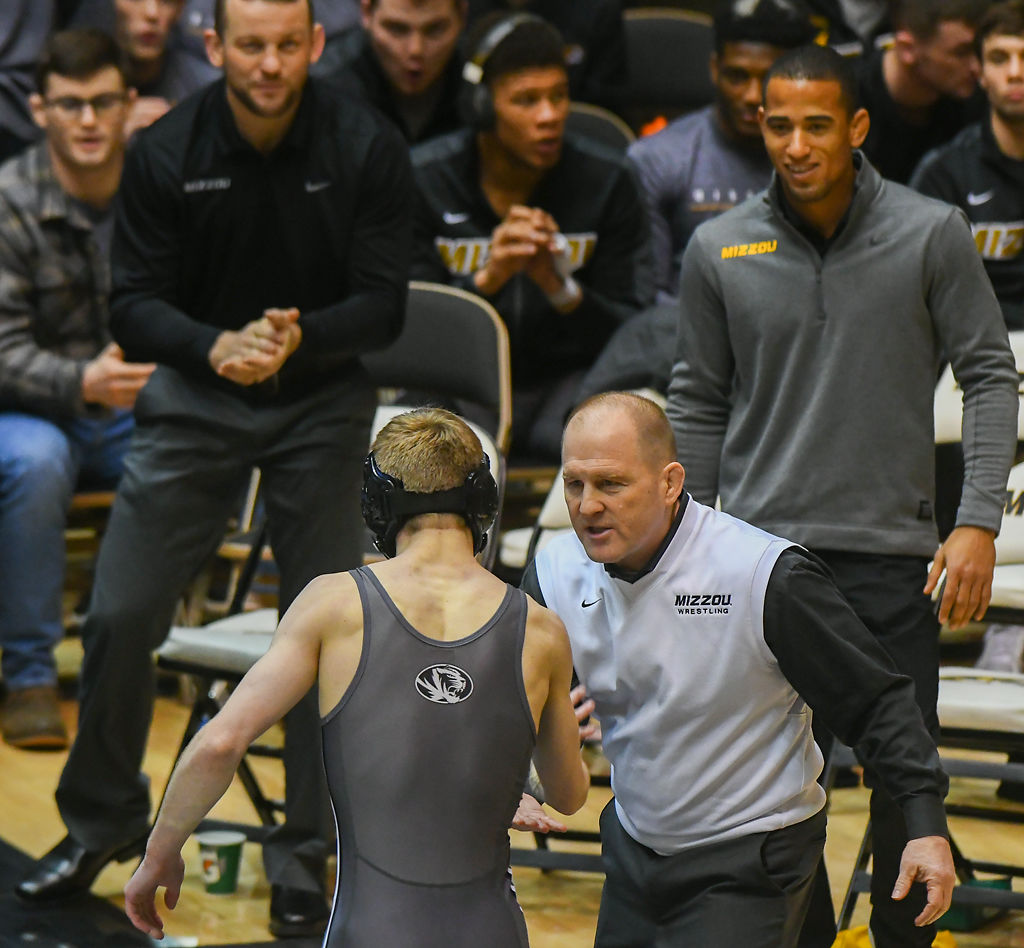 Cameron Valdiviez is congratulated by head coach Brian Smith following his win against Bryce West